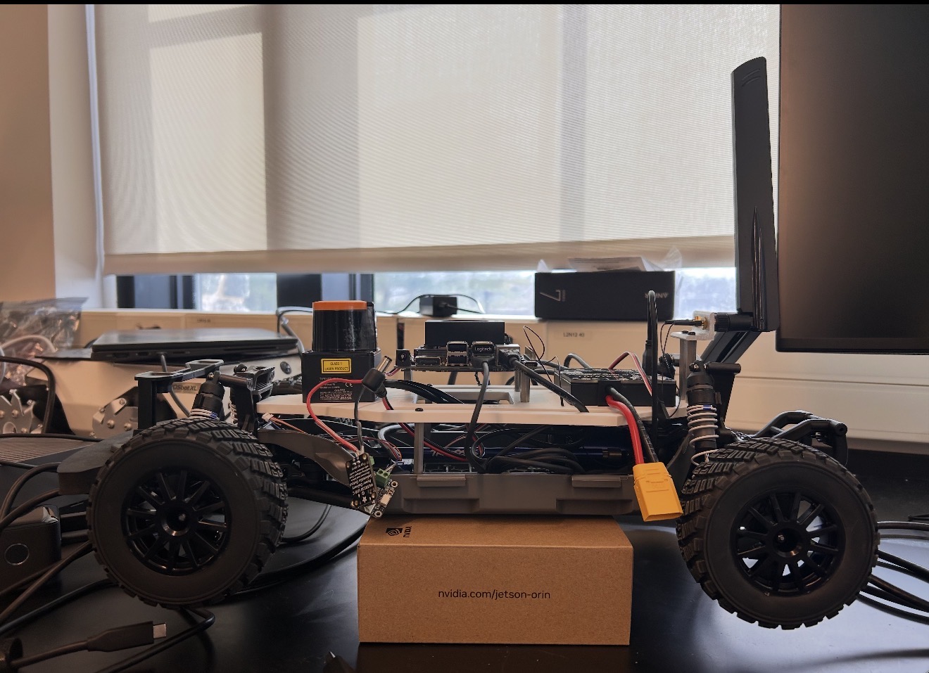 Side view of the F1/10 research vehicle on a lab bench